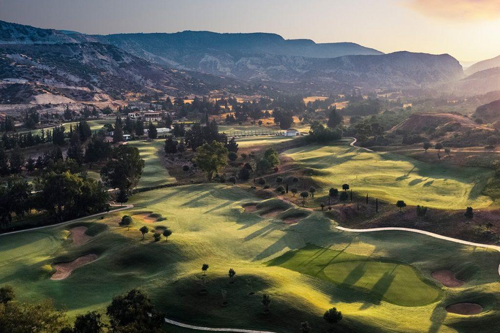 Aerial photograph early morning light over Secret Valley Golf Resort golf course, with ancient rock formations in the background.