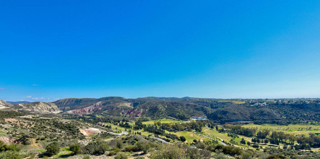 Panoramic view of Secret Valley Golf Resort from the housing area nearby, with blue sky in background.