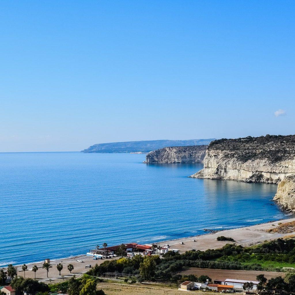 View of Kourion beach, Mediterranean sea and limestone cliffs. Cyprus. Presented by Comark Estates.