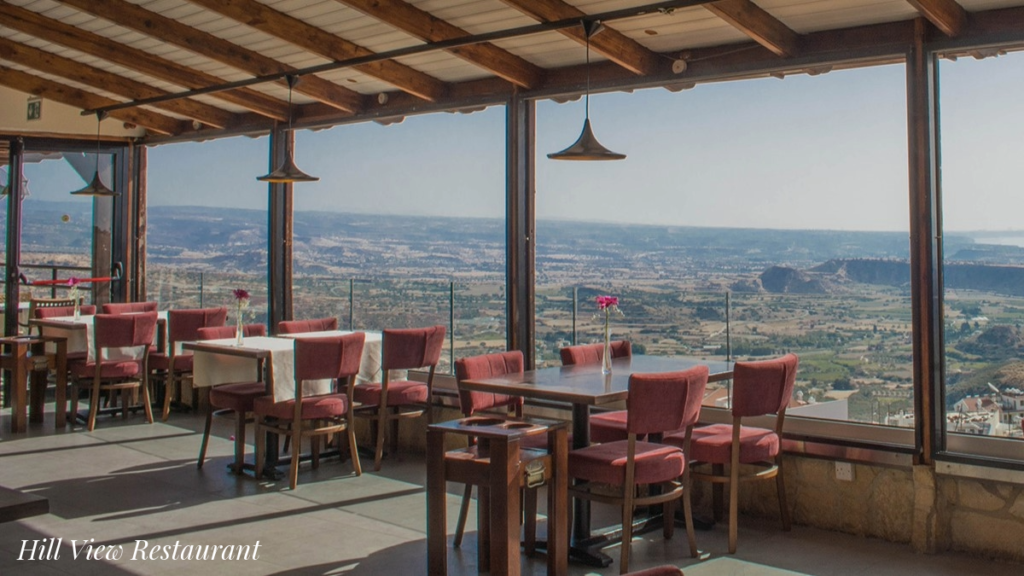 Photo of dining tables set up in the Hill View Restaurant, Pissouri, with wonderful inland views