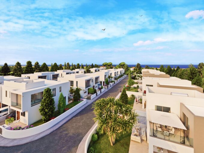 CGI image of new development of houses, showing road and rows of villas, with trees and sea in the backdrop