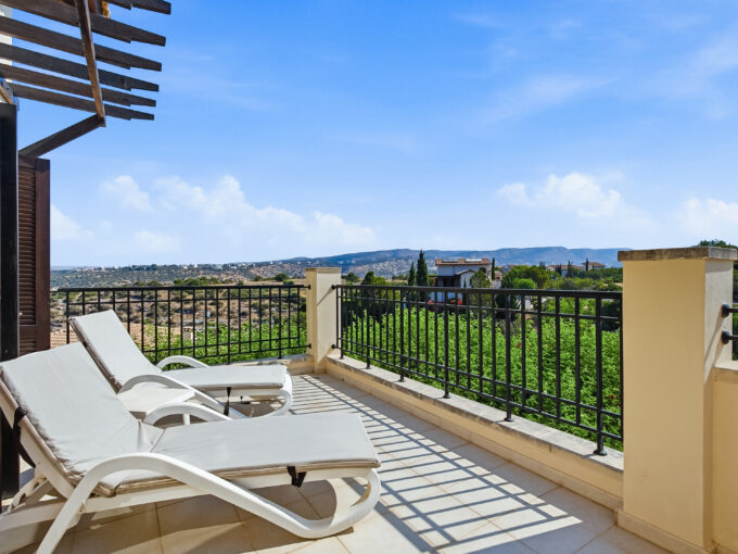 Photo of apartment balcony with sunbeds, showing mountain view
